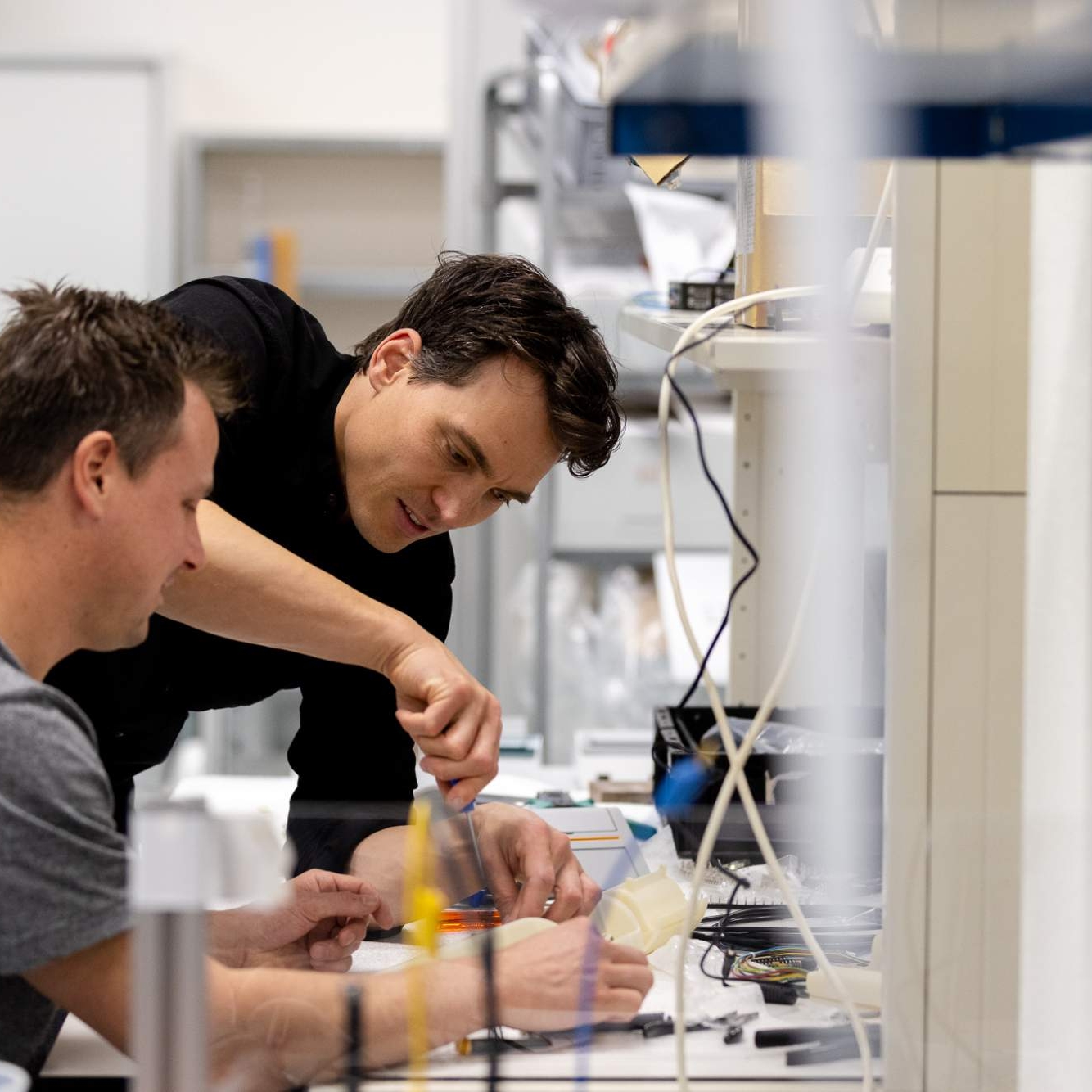 Male_colleagues_engineering_helping_other