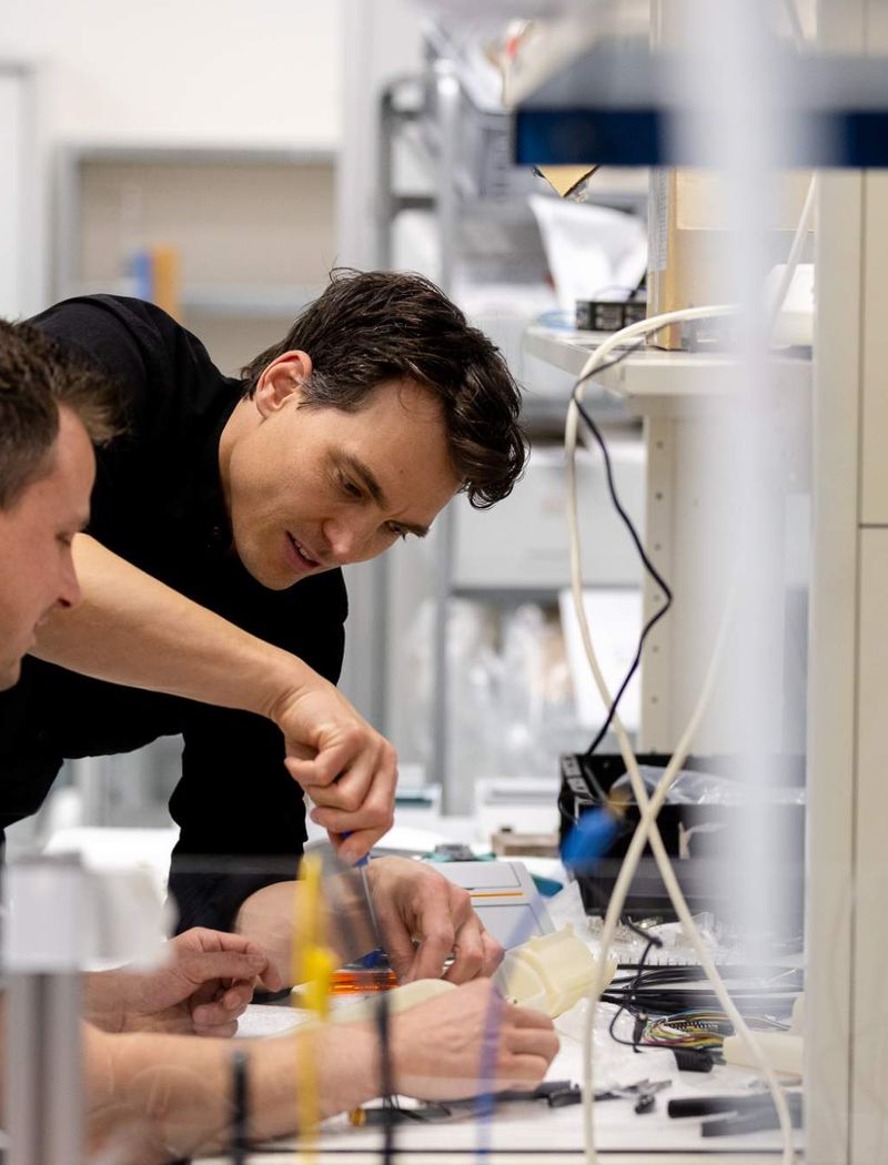 Male_colleagues_engineering_helping_other