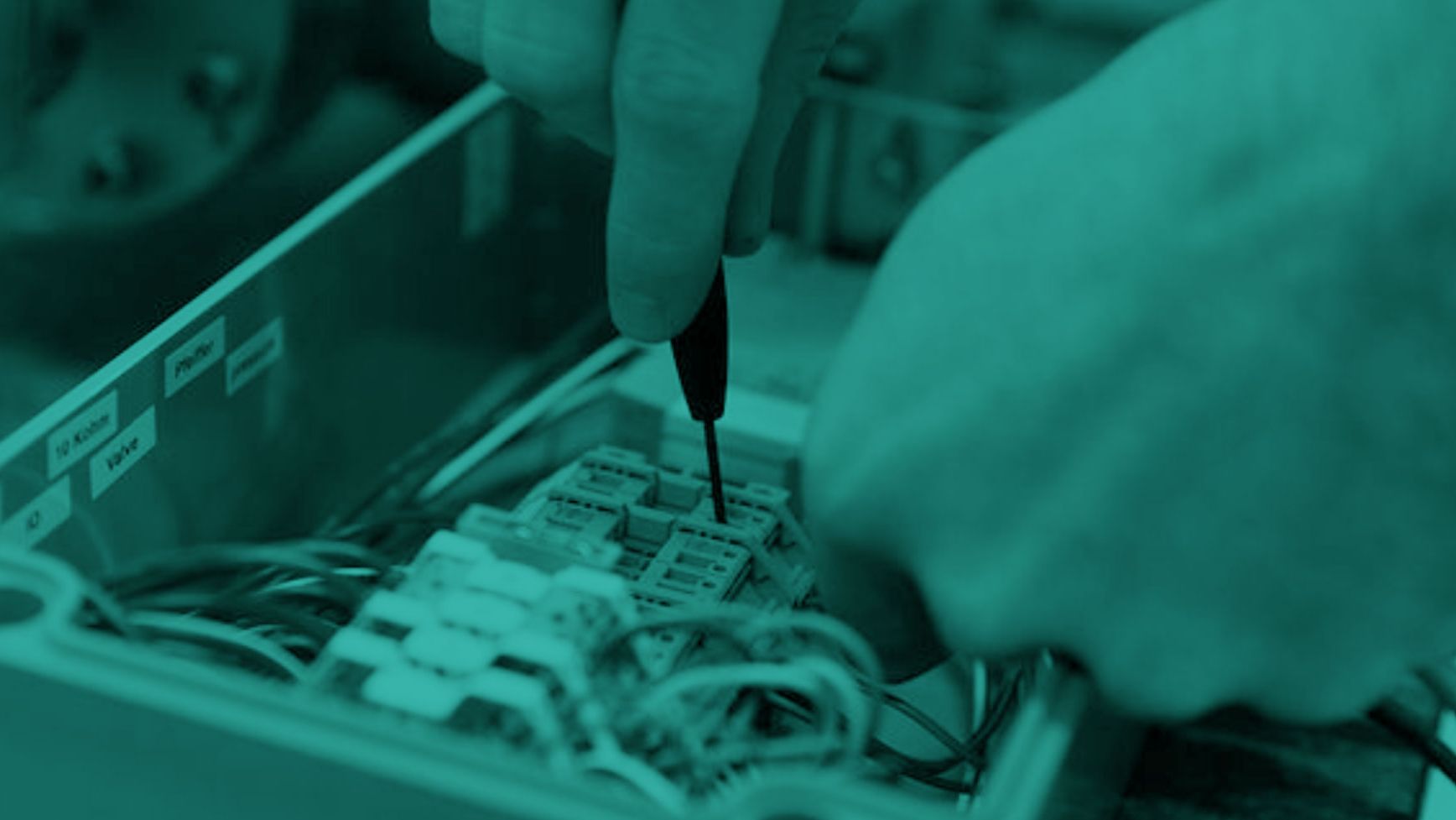 Homepage_header_hands_electrical_component_machine